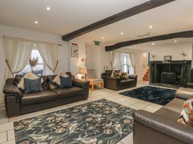 A living room with sofas and a fireplace at Newlands Fell House in Newlands near Keswick