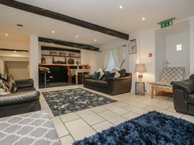 A living room with sofas and a dining area at Newlands Fell House in Newlands near Keswick