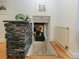 A staircase with a stone wall and plant decoration at Newlands Fell House near Keswick