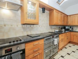 A kitchen with cabinets and appliances at Newlands Fell House in Newlands near Keswick