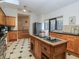 A kitchen with wooden cabinets and a central island at Newlands Fell House in Newlands near Keswick