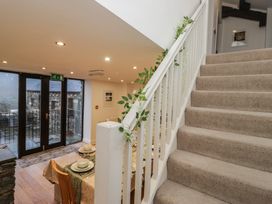 A dining room with staircase and sliding door at Newlands Fell House, Newlands near Keswick