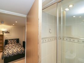 A bedroom with a bed and a shower area at Newlands Fell House in Newlands near Keswick