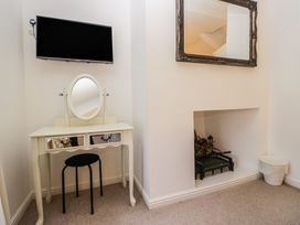 A dressing room with a vanity table and TV at Newlands Fell House in Newlands near Keswick