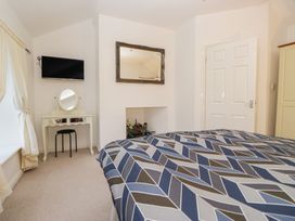 A bedroom with a television and a dressing table at Newlands Fell House near Keswick