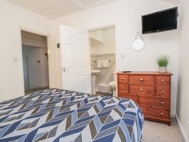 A bedroom with a bed and dresser at Newlands Fell House in Newlands near Keswick