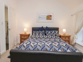 A bedroom with a bed and bedside tables at Newlands Fell House in Newlands near Keswick