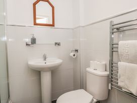 A bathroom with sink, toilet and mirror at Newlands Fell House near Keswick
