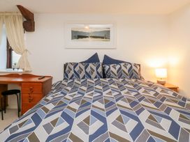 A bedroom with a bed and desk at Newlands Fell House in Newlands near Keswick