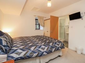 A bedroom with a bed and en suite bathroom at Newlands Fell House in Newlands near Keswick