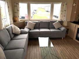 A living room with a sofa and coffee table at Gannet 16 (G16) Bridge Of Allan