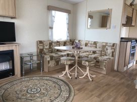 A living room with a sofa and table at Gannet 16 (G16) Bridge Of Allan