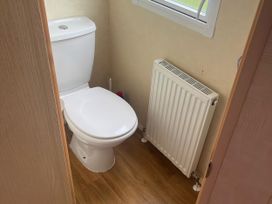 A bathroom with a toilet and radiator at Gannet 16 (G16) Bridge Of Allan