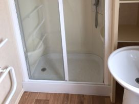 A bathroom with a shower and sink at Gannet 16 (G16) Bridge Of Allan