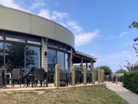 An outdoor seating area with tables and chairs at Gannet 16 (G16) Bridge Of Allan