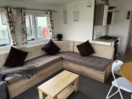 A living room with a sofa and a table at Jay valley 35 (J35) in Lichfield