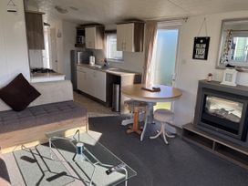 A living room with a sofa and a table at Jay valley 35 (J35) in Lichfield