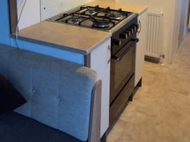 A kitchen with a gas stove and oven at Jay valley 35 (J35) in Lichfield