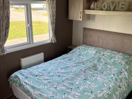 A bedroom with a bed and window at Jay valley 35 (J35) in Lichfield