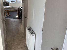 A hallway with a radiator and doors at Jay valley 35 (J35) Lichfield
