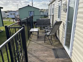 A balcony with a table and chair at Jay valley 35 (J35) in Lichfield