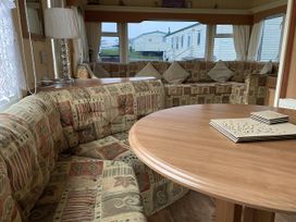 A living room with a sofa and table at Gannet 18 (G18) in Bridlington