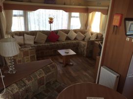 A living room with a corner sofa and coffee table at Gannet 18 (G18) Bridlington