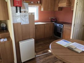 A kitchen with a table and appliances at Gannet 18 (G18) Bridlington