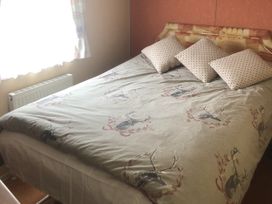A bedroom with a bed and pillows at Gannet 18 (G18) Bridlington