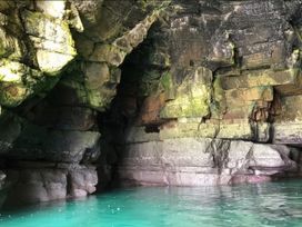 A cave with rock formations and water inside at Gannet 18 (G18) Bridlington