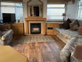 A living room with a television and sofa at Gannet 19 (G19) Bridlington