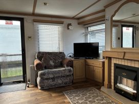 A living room with an armchair and television at Gannet 19 (G19) in Bridlington