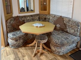 A dining area with a table and seating at Gannet 19 (G19) in Bridlington