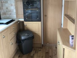A kitchen with cabinets and an oven at Gannet 19 (G19) Bridlington