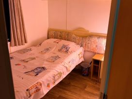 A bedroom with a bed and nightstand at Gannet 19 (G19) in Bridlington
