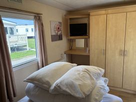 A bedroom with a bed and television at Dunlin dell 45 (D45) Bridlington
