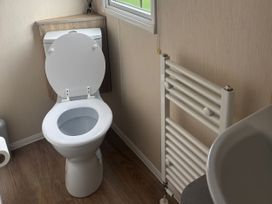 A bathroom with a toilet and towel radiator at Skegness Holiday Park Skegness