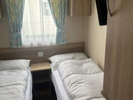 A bedroom with two single beds at Skegness Holiday Park in Skegness