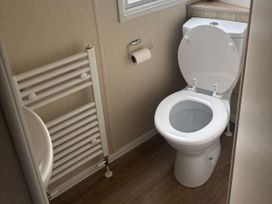 A bathroom with a toilet and sink at Skegness Holiday Park in Skegness