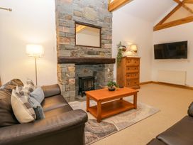 A living room with a fireplace and furniture at Newlands Fell Cottage in Newlands near Keswick