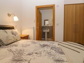 A bedroom with a bed and a view to a washroom at Newlands Fell Cottage in Newlands near Keswick