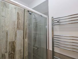 A bathroom with a shower and towel rail at Newlands Fell Cottage near Keswick