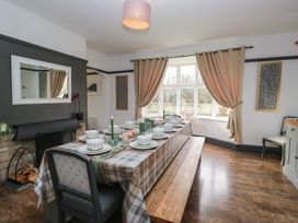 A dining room with a table set for dinner at Herdwick Croft in Bassenthwaite