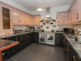 A kitchen with cabinets, oven, sink and countertop at Herdwick Croft in Bassenthwaite