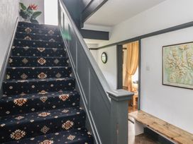 A hallway with stairs and a map on the wall at Herdwick Croft in Bassenthwaite