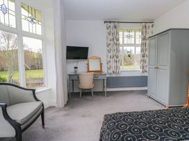A bedroom with a desk and chair at Herdwick Croft in Bassenthwaite