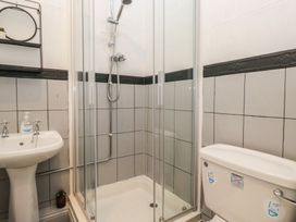 A bathroom with a shower, toilet, and sink at Herdwick Croft in Bassenthwaite