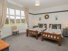 A bedroom with two single beds and a chair at Herdwick Croft in Bassenthwaite