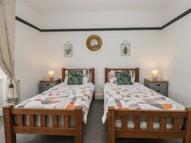 A bedroom with two single beds and nightstands at Herdwick Croft in Bassenthwaite