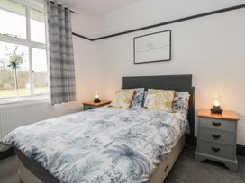 A bedroom with a bed and bedside tables at Herdwick Croft in Bassenthwaite
